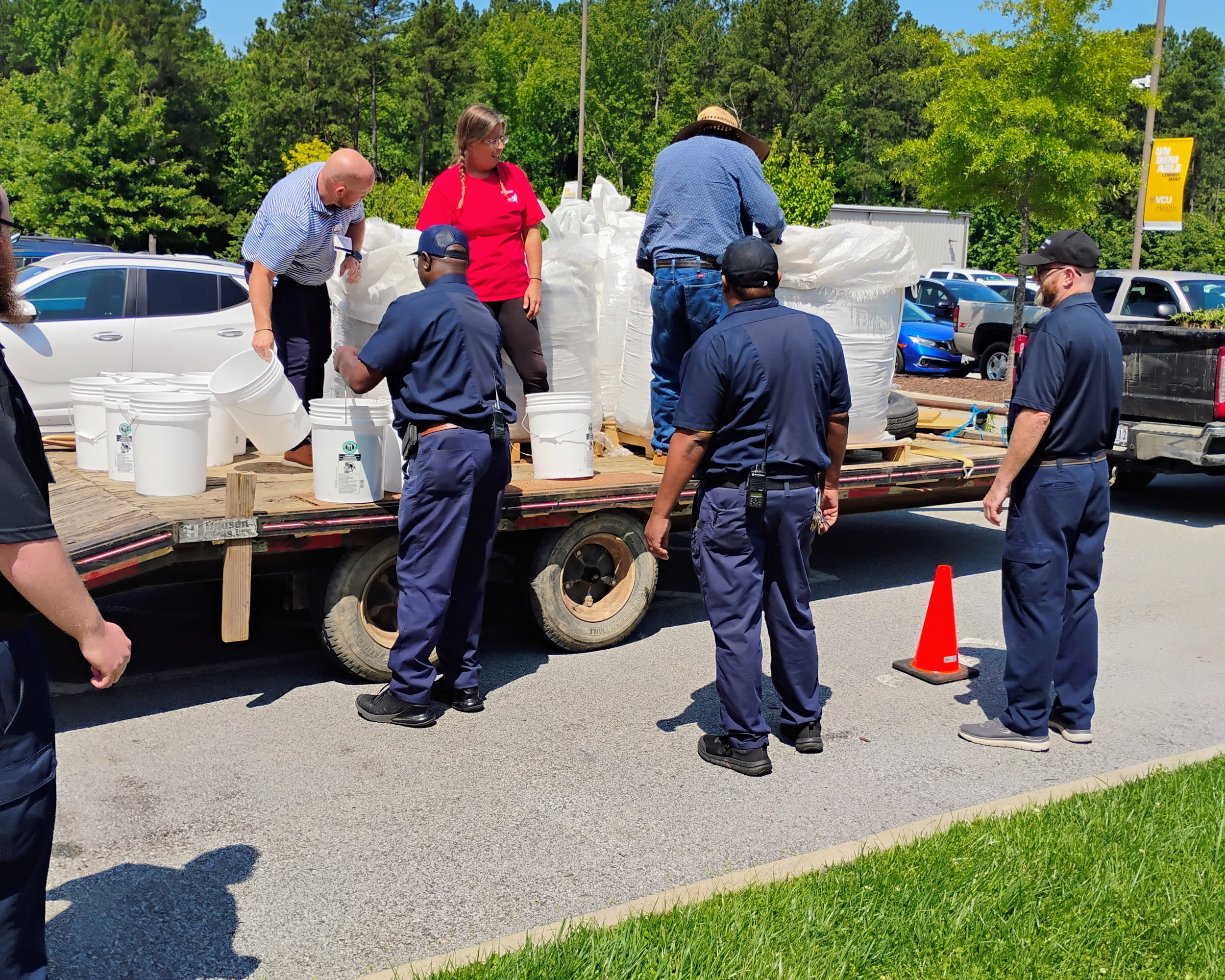 people unloading a trailer of supplies for gardening
